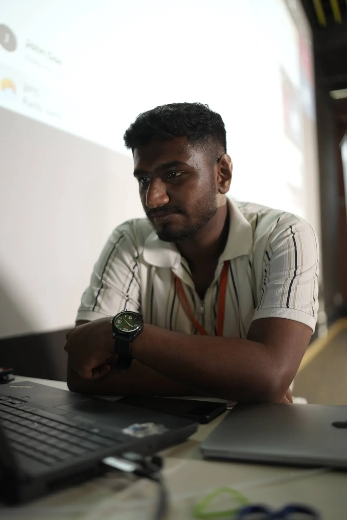 Nithin Daniel working on a laptop during a tech workshop